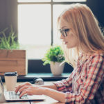 Lady reading on laptop