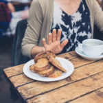 Diner refusing plate of bread